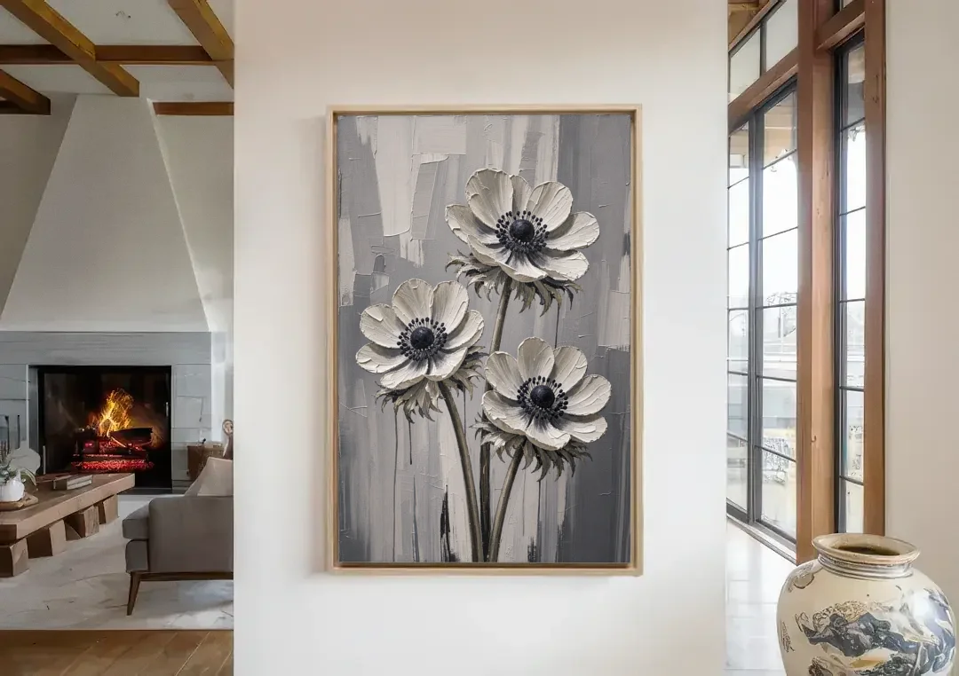 Three White Anemones with Black Centers canvas wall art in a living room with a fireplace