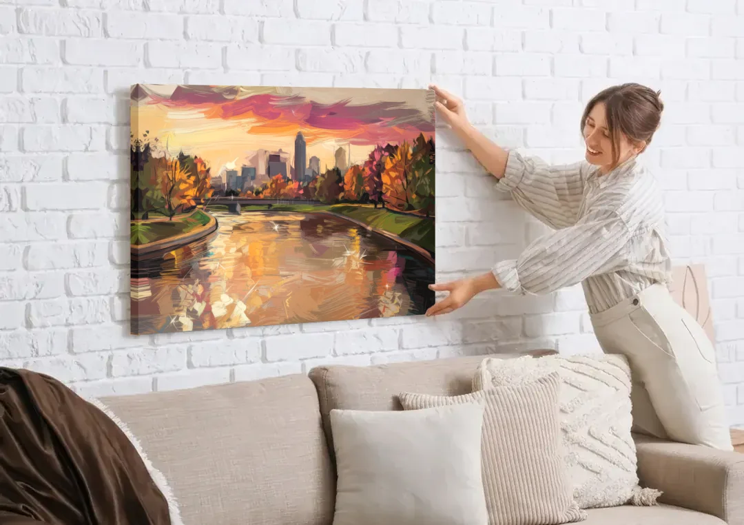 Toledo Maumee River Sunset canvas wall art being hung on a white brick wall above a sofa