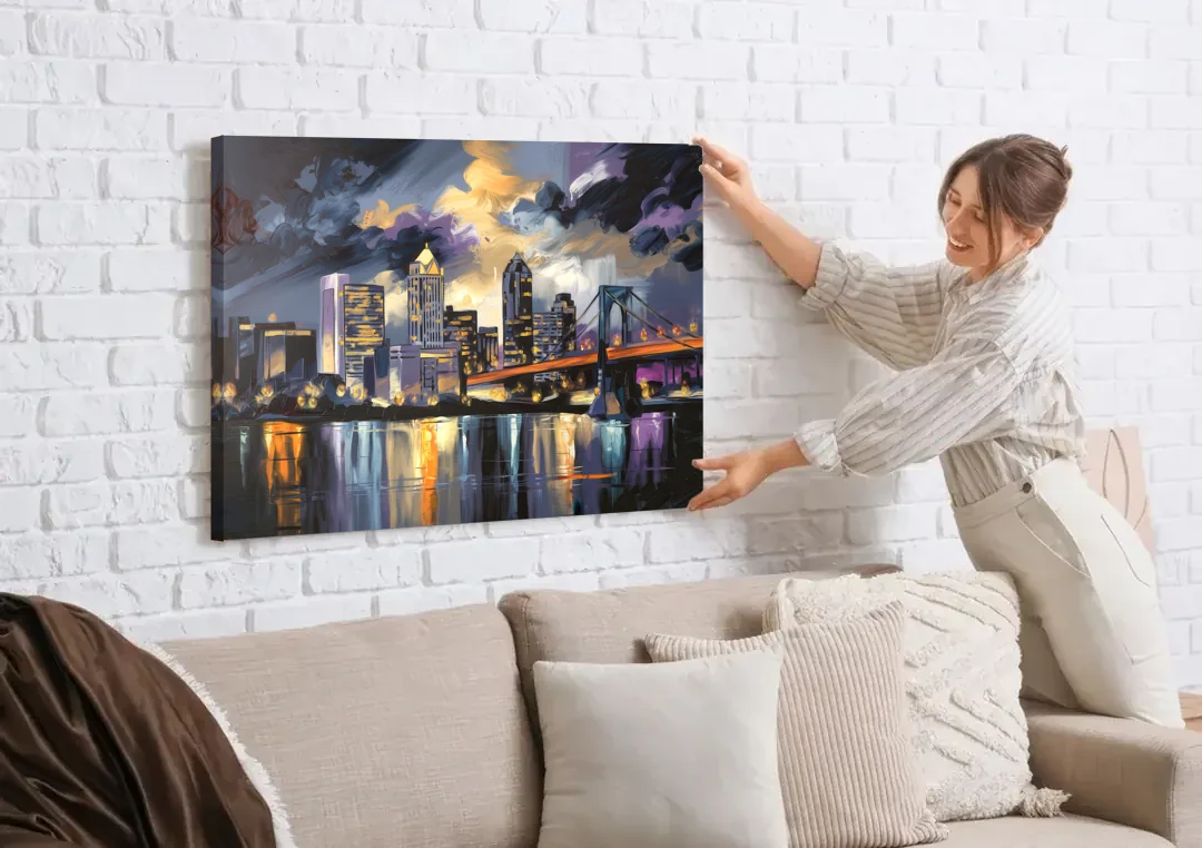 Toledo Nighttime Skyline canvas wall art being hung on a white brick wall above a sofa