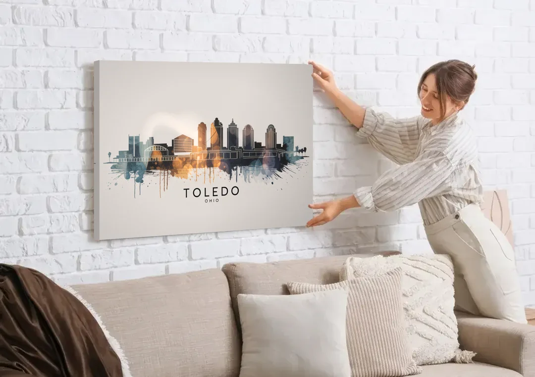 Toledo Skyline Panorama canvas wall art being hung on a white brick wall above a sofa