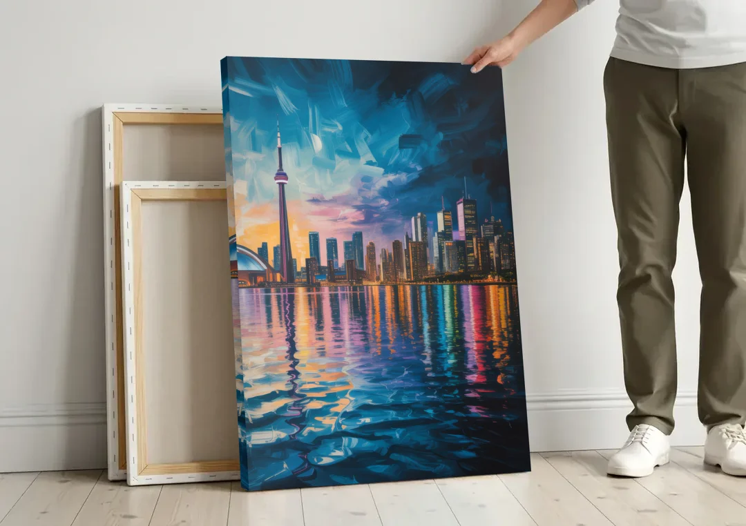 Toronto Skyline at Night Watercolor canvas wall art leaning against a wall next to blank canvases