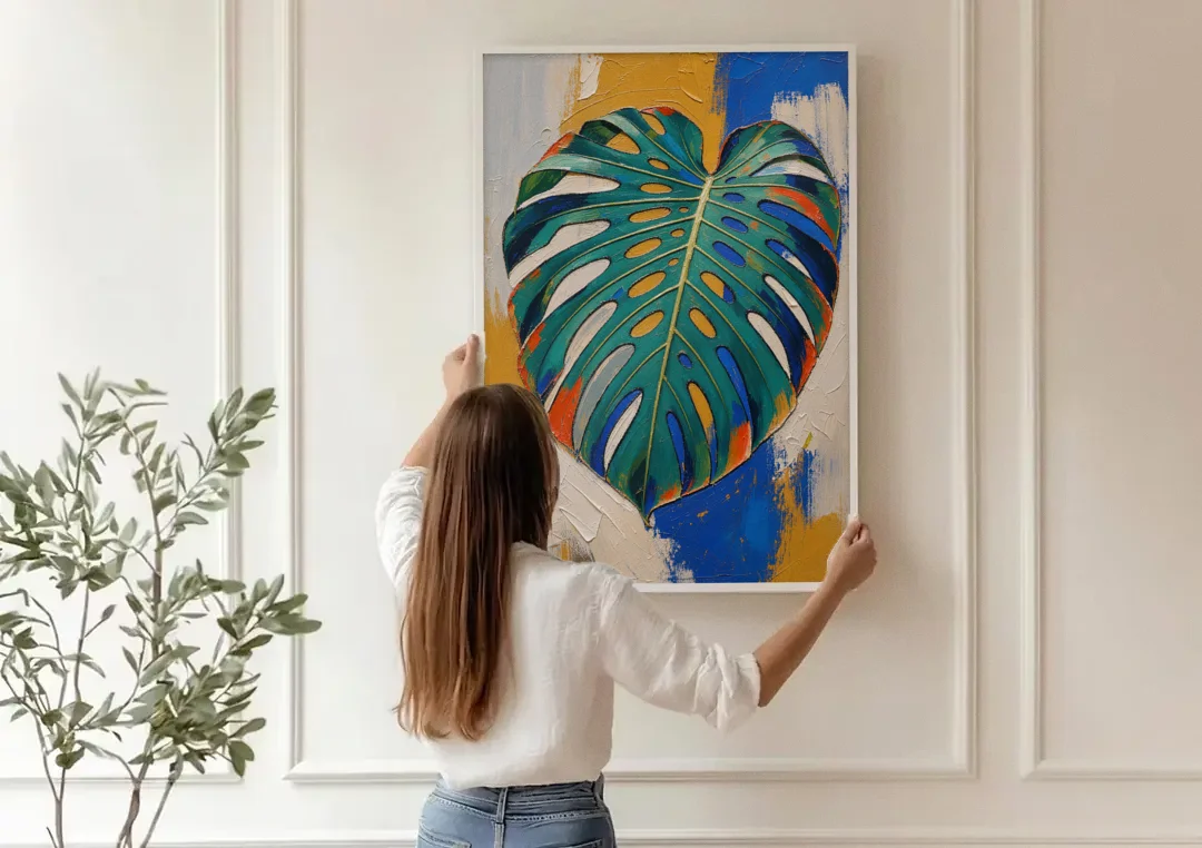 Tropical Teal Monstera Leaf Impasto canvas wall art being hung on a paneled wall