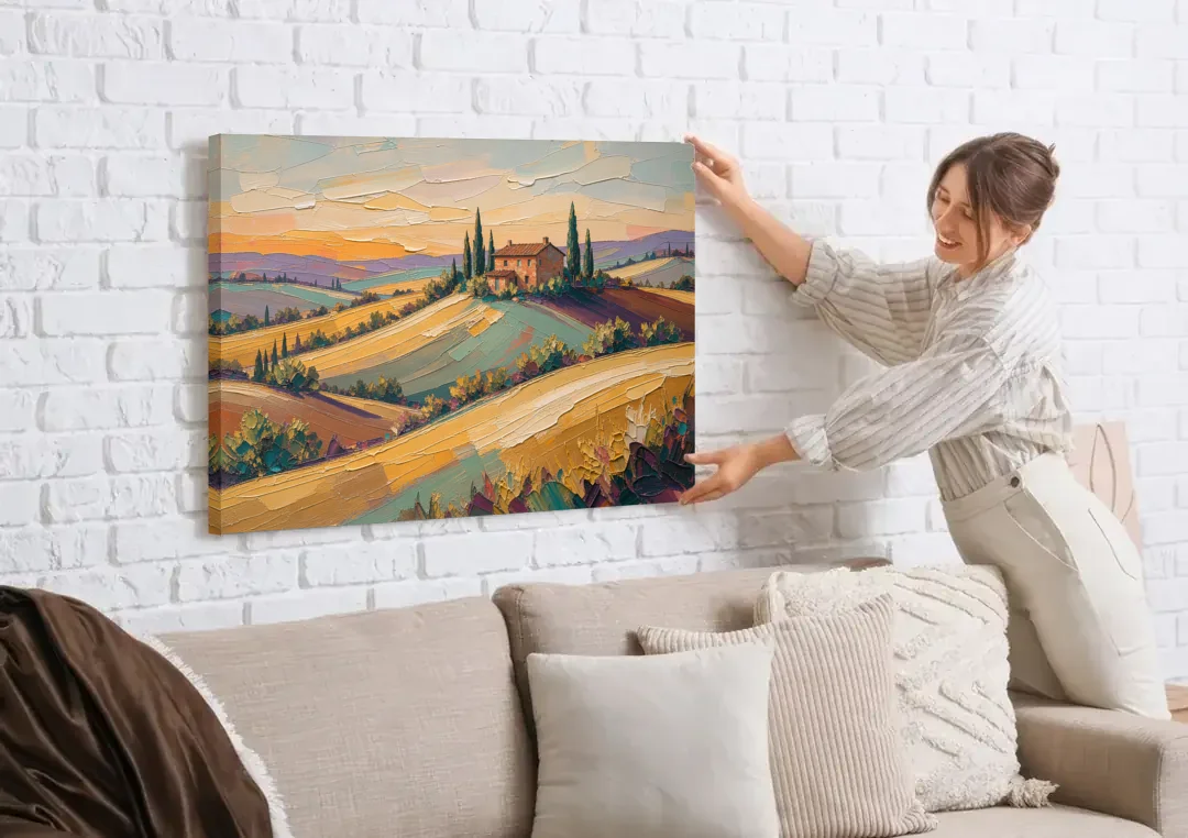 Tuscan Landscape Painting of Farmhouse Crest canvas wall art being hung on a white brick wall above a sofa
