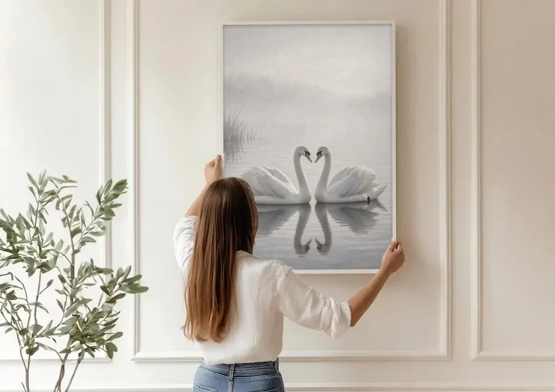 Two Black and White Swans Made for Each Other canvas wall art being hung on a paneled wall
