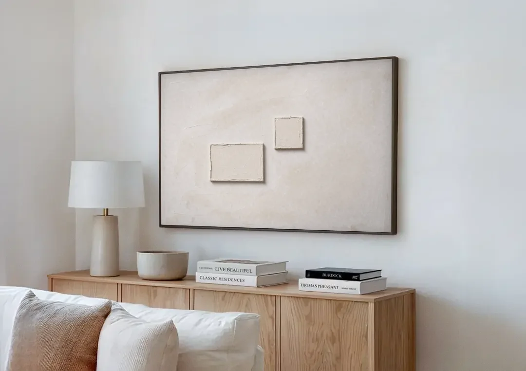 Two Offset Off-White Relief Blocks on Plaster canvas wall art above a wooden sideboard next to a sofa