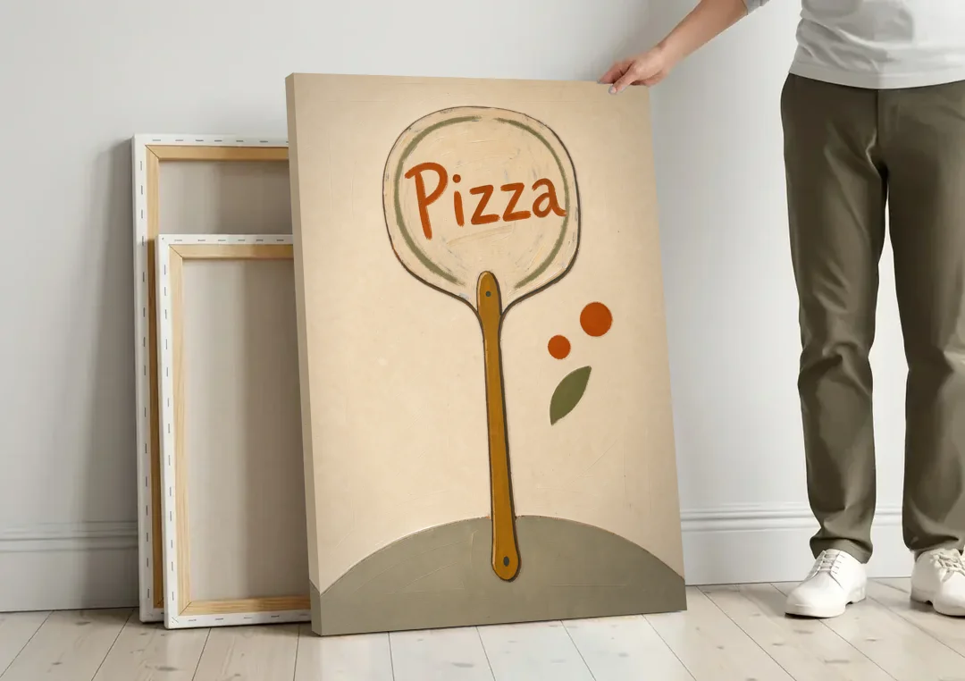 Upright Pizza Peel Sign with Basil Leaf canvas wall art leaning against a wall next to blank canvases