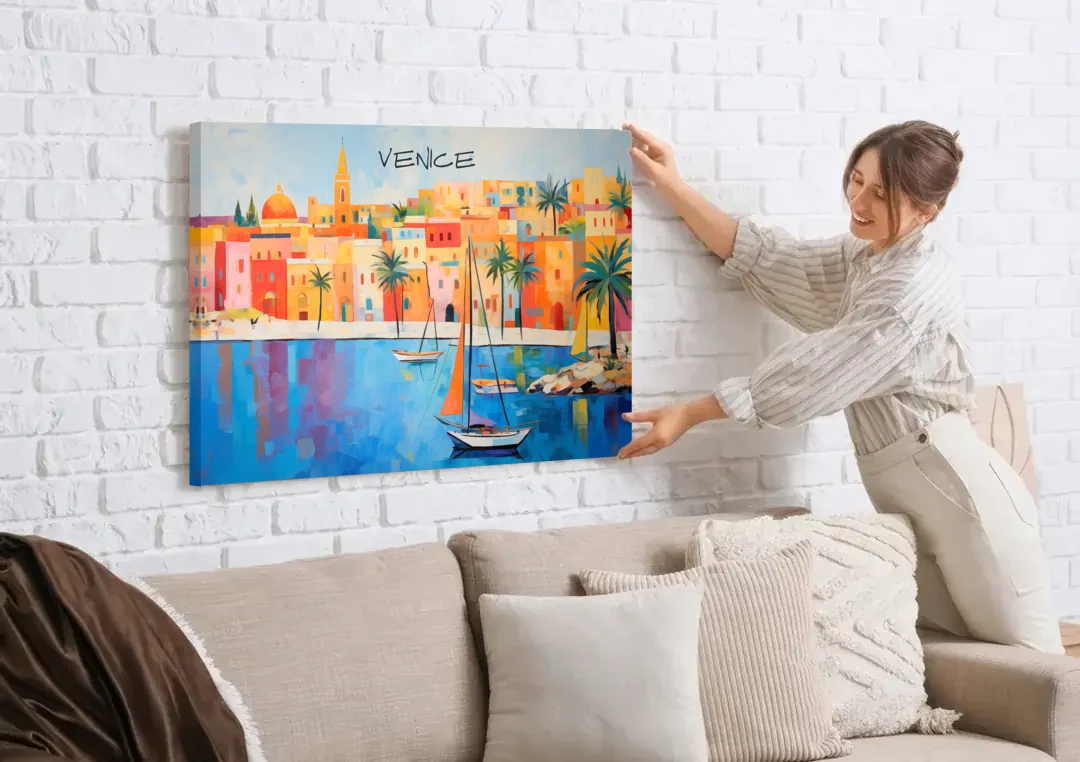 Venice Art with an Orange Sail canvas wall art being hung on a white brick wall above a sofa