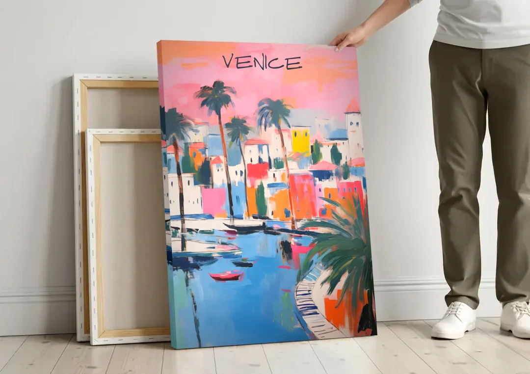 Venice Wall Art Under a Pink Sky canvas wall art leaning against a wall next to blank canvases