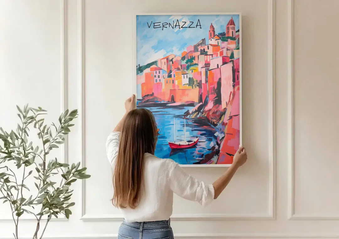 Vernazza Painting with Red Boats canvas wall art being hung on a paneled wall
