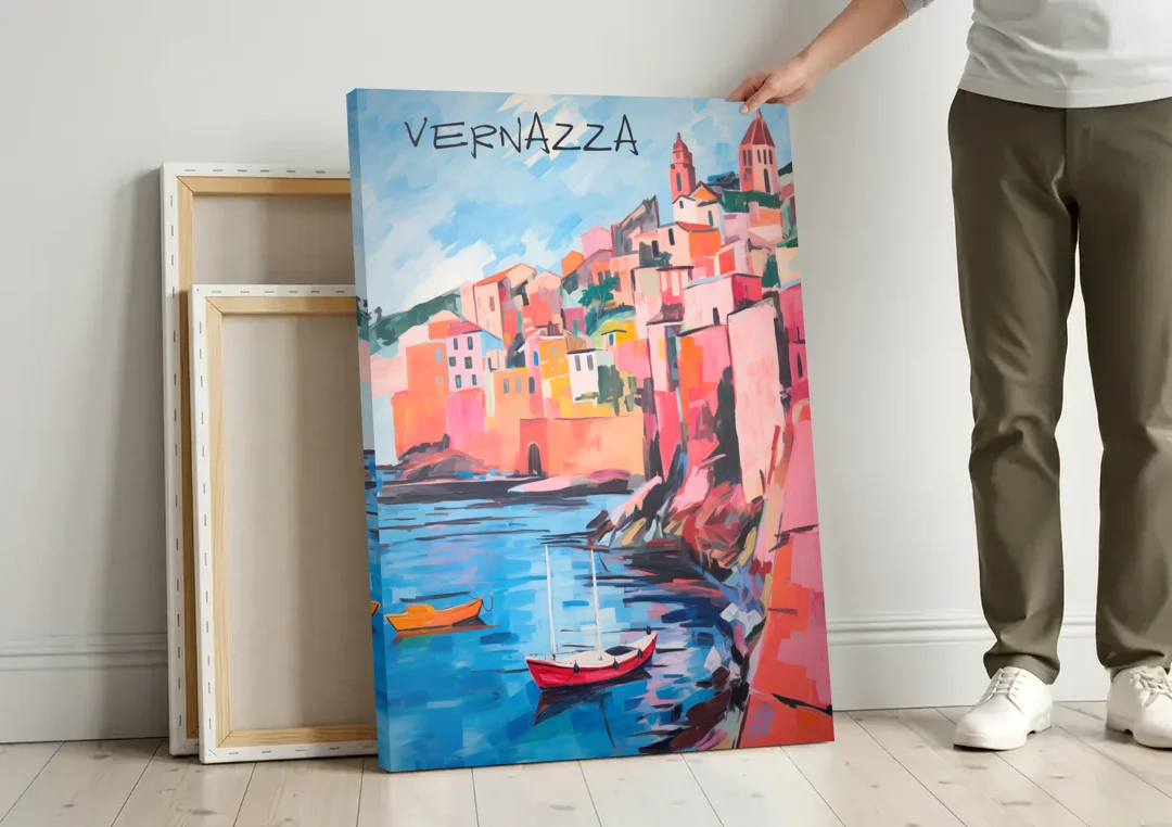 Vernazza Painting with Red Boats canvas wall art leaning against a wall next to blank canvases