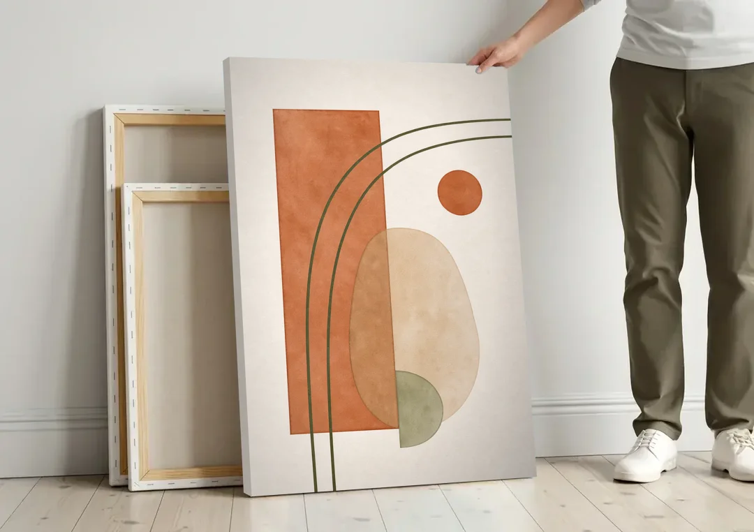 Vertical Abstract Wall Art with Olive Arcs canvas wall art leaning against a wall next to blank canvases