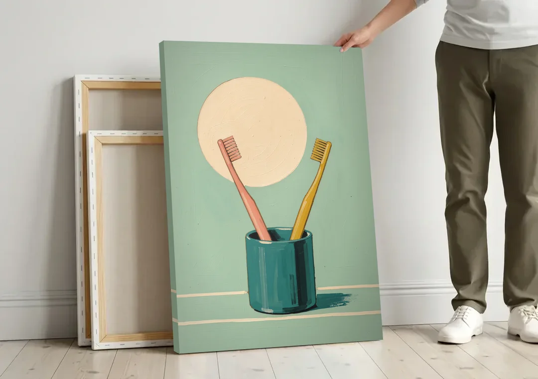 Vintage Bathroom Wall Art of Two Toothbrushes canvas wall art leaning against a wall next to blank canvases
