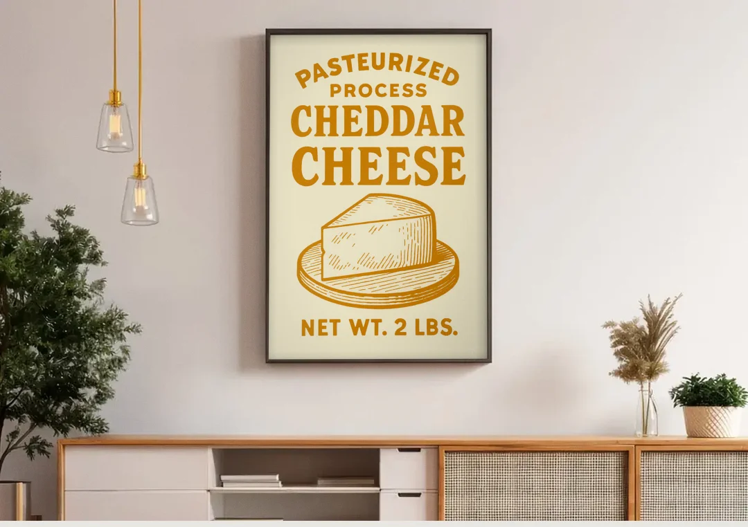 Vintage Cheddar Cheese canvas wall art above a wooden sideboard under pendant lights