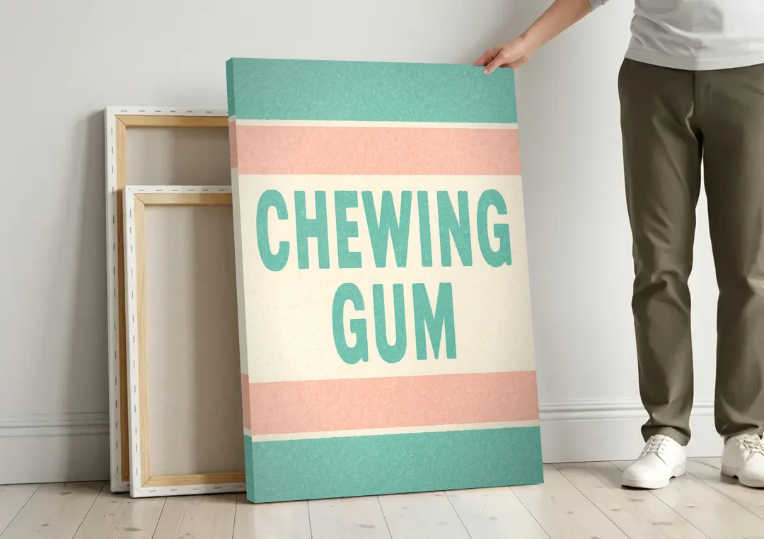 Vintage Chewing Gum canvas wall art leaning against a wall next to blank canvases