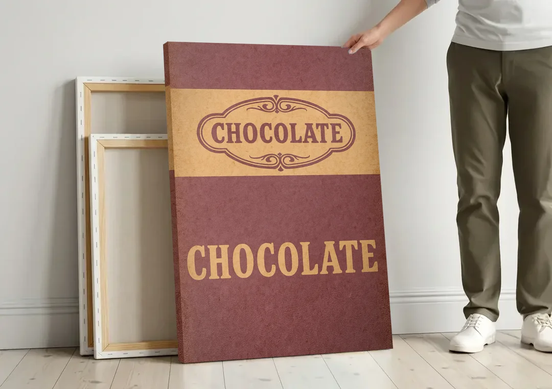 Vintage Chocolate Bar canvas wall art leaning against a wall next to blank canvases