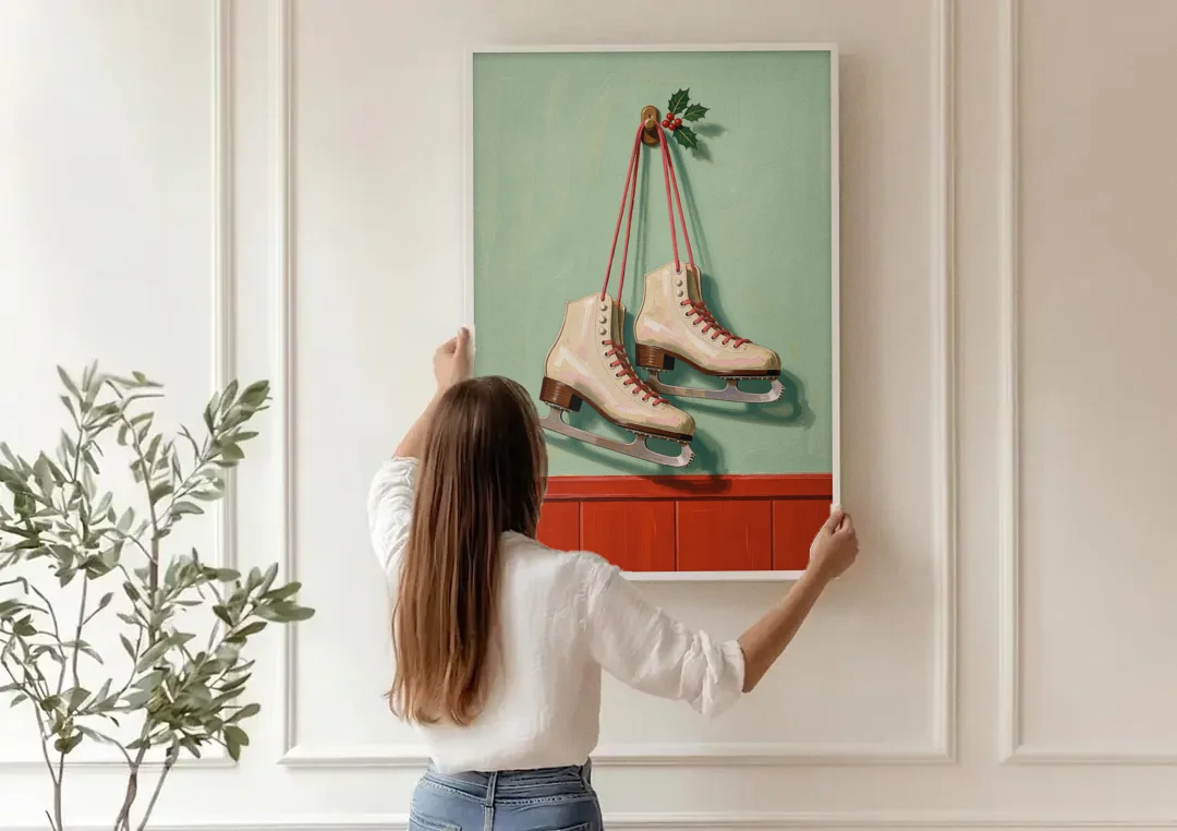 Vintage Christmas Wall Art of Hanging Ice Skates canvas wall art being hung on a paneled wall