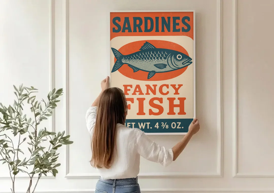 Vintage Fancy Fish Sardines canvas wall art being hung on a paneled wall