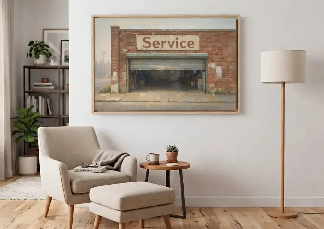 Vintage Garage Signs Service Over the Open Bay canvas wall art above an armchair in a bright living room