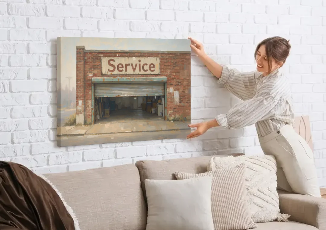 Vintage Garage Signs Service Over the Open Bay canvas wall art being hung on a white brick wall above a sofa