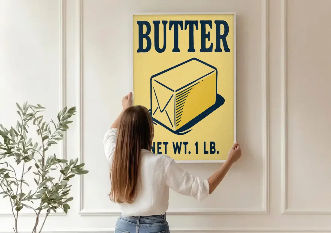 Vintage Natural Butter canvas wall art being hung on a paneled wall