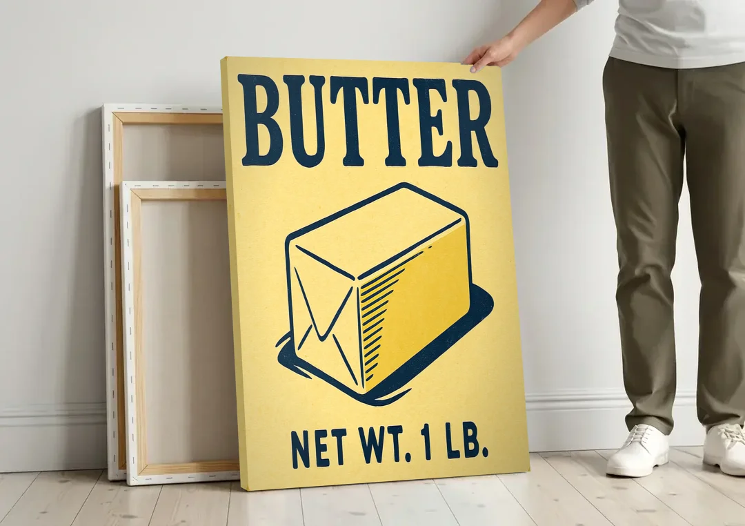 Vintage Natural Butter canvas wall art leaning against a wall next to blank canvases