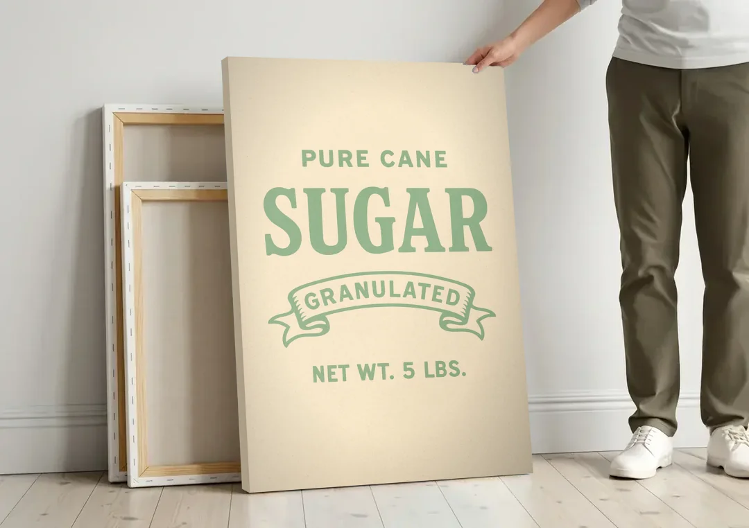 Vintage Pure Cane Sugar canvas wall art leaning against a wall next to blank canvases