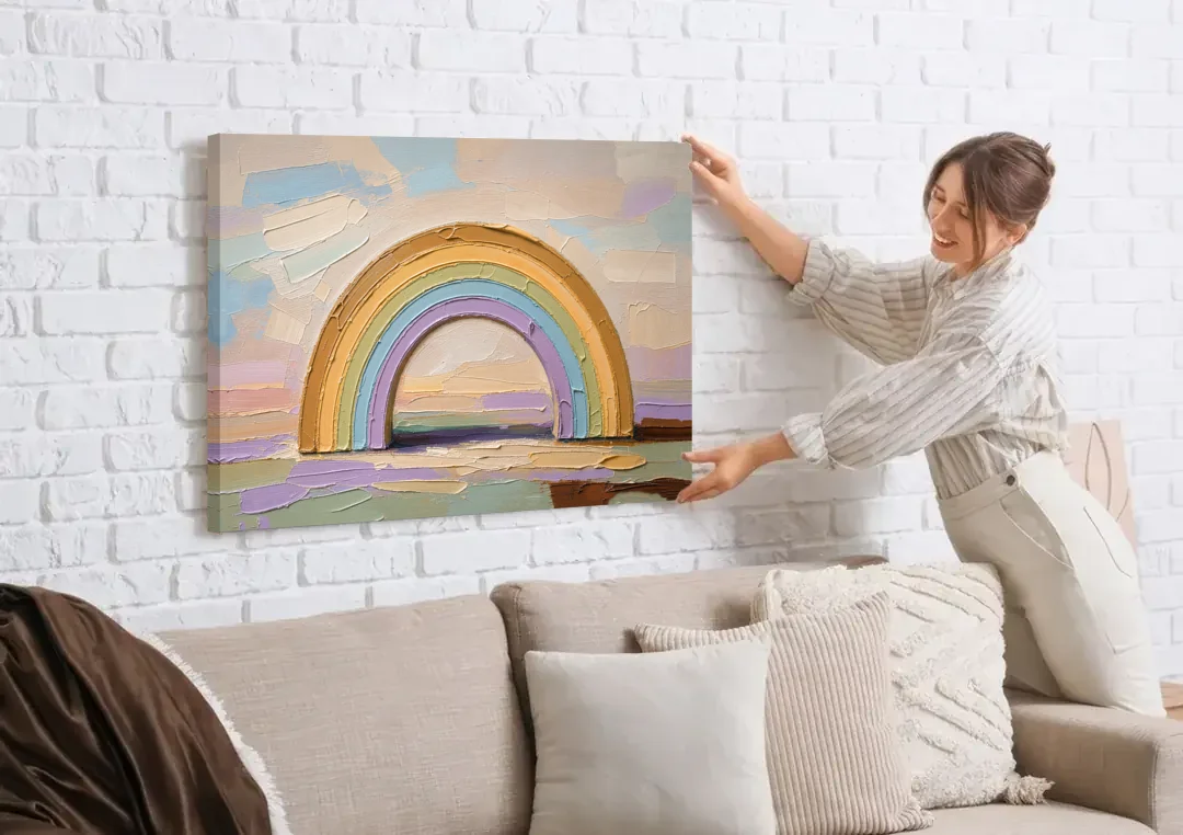 Wall Art Above Couch Ochre Rainbow Arch canvas wall art being hung on a white brick wall above a sofa