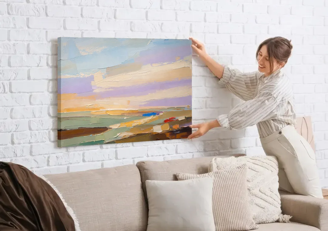 Wall Art Above Sofa Lilac Haze Meadow canvas wall art being hung on a white brick wall above a sofa