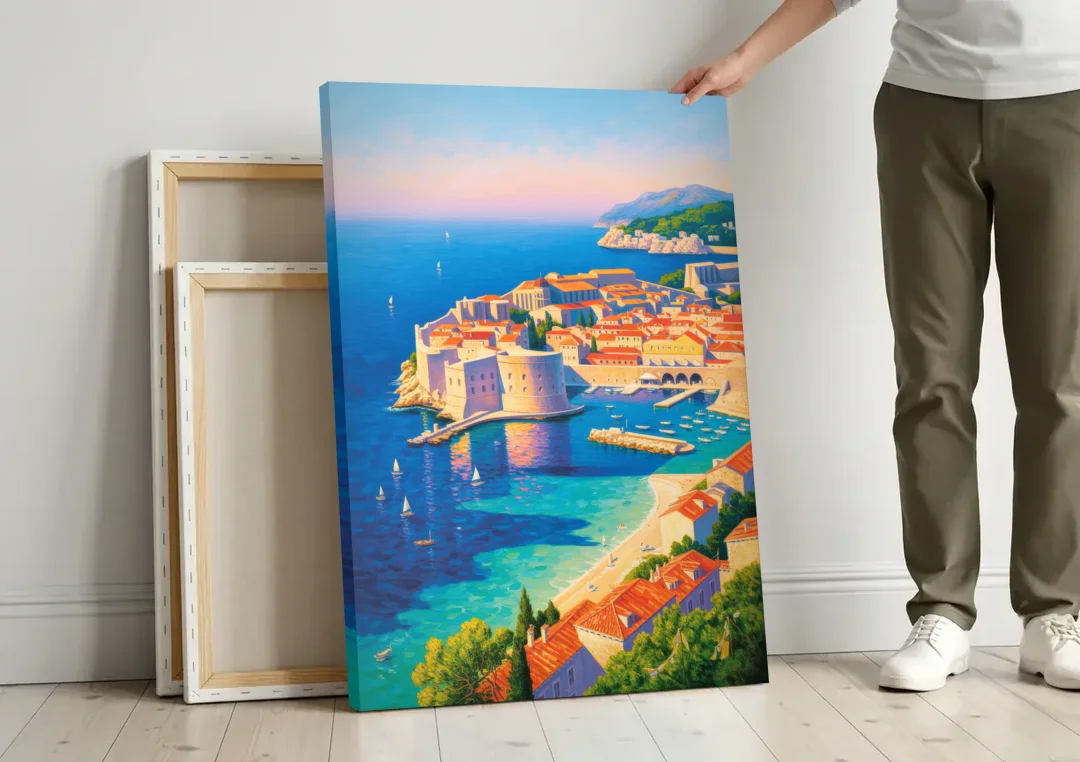 Walls of Dubrovnik canvas wall art leaning against a wall next to blank canvases