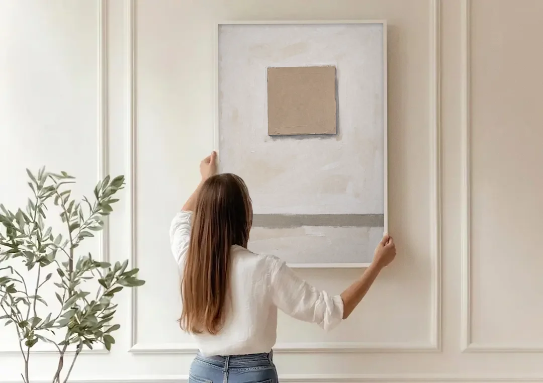 Warm Neutral Wall Art with a Floating Clay Square canvas wall art being hung on a paneled wall