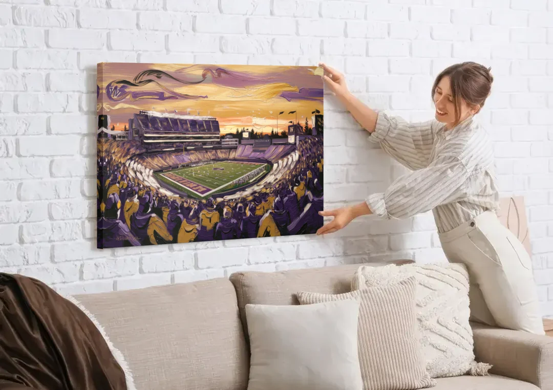 Washington Huskies Spirit canvas wall art being hung on a white brick wall above a sofa