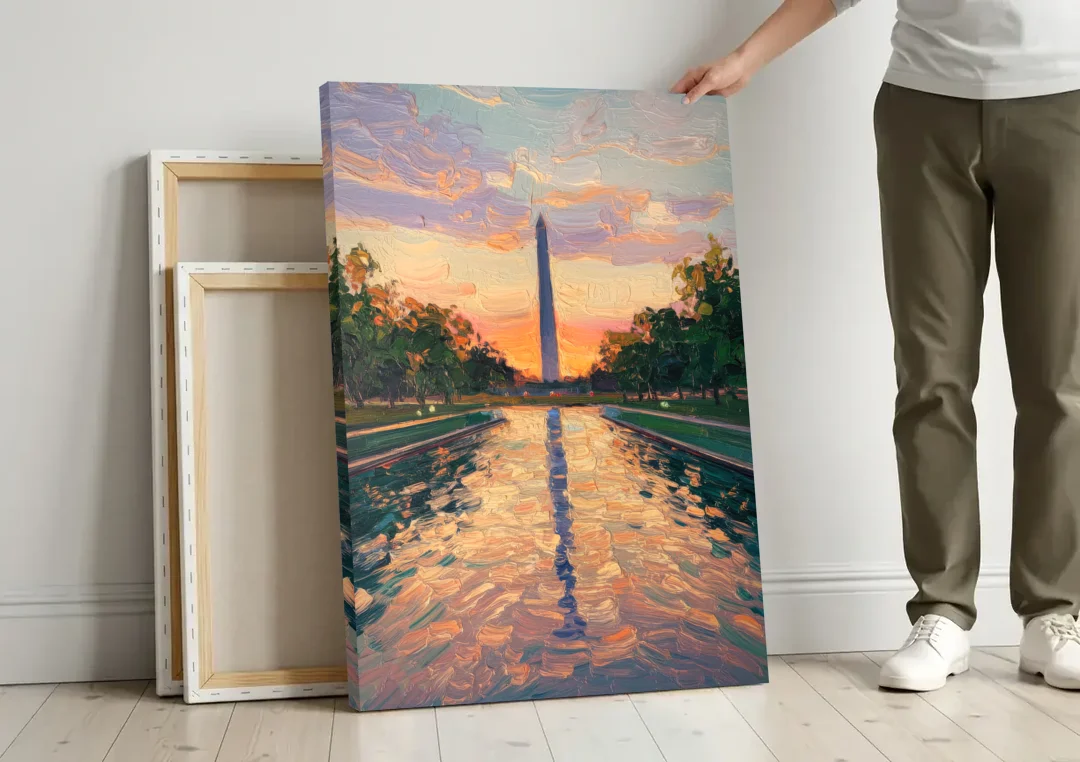 Washington Monument Reflection canvas wall art leaning against a wall next to blank canvases