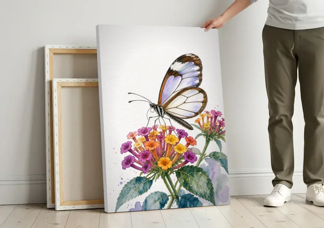 Watercolor Butterfly Painting of a Glasswing on Lantana canvas wall art leaning against a wall next to blank canvases
