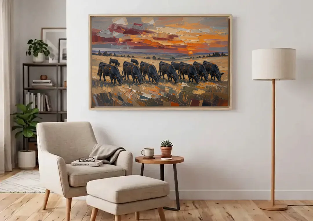 Western Wall Art of Angus Grazing at Sundown canvas wall art above an armchair in a bright living room