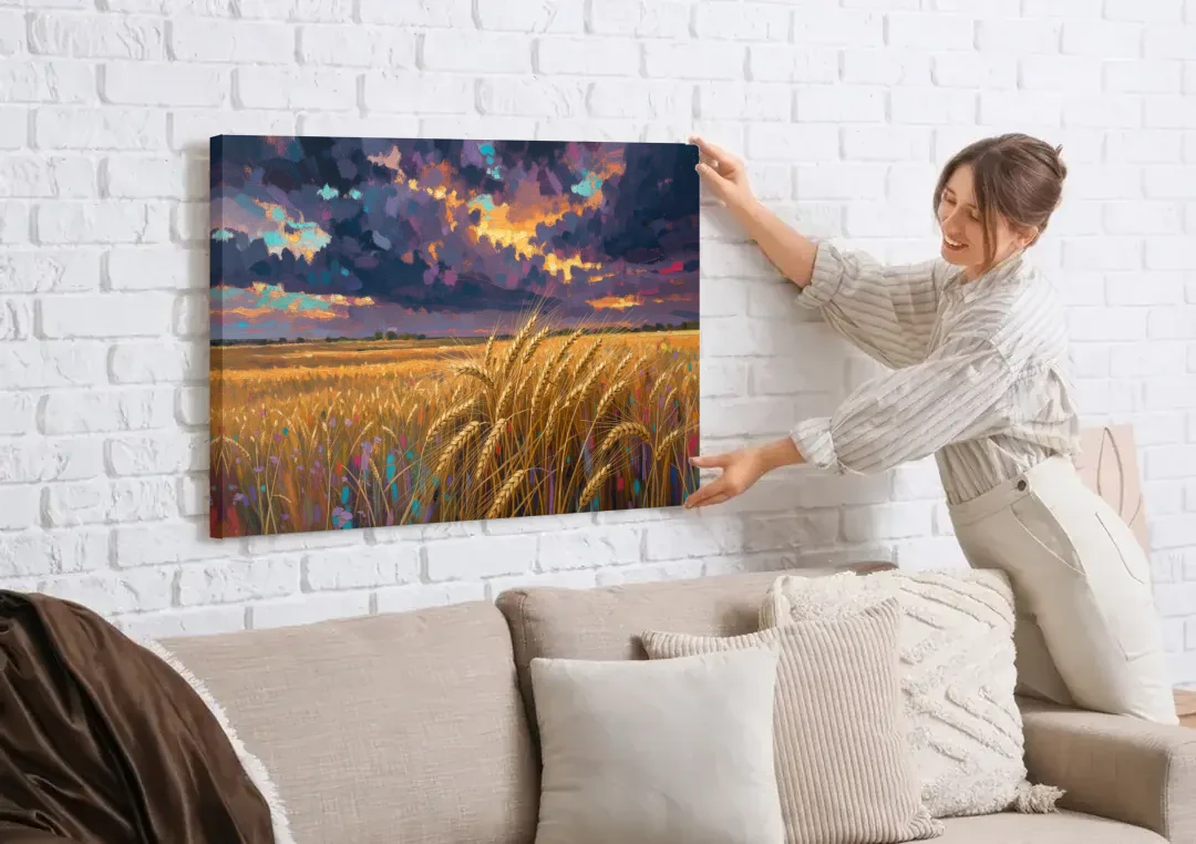 Wheat Field Painting Under a Gathering Storm canvas wall art being hung on a white brick wall above a sofa