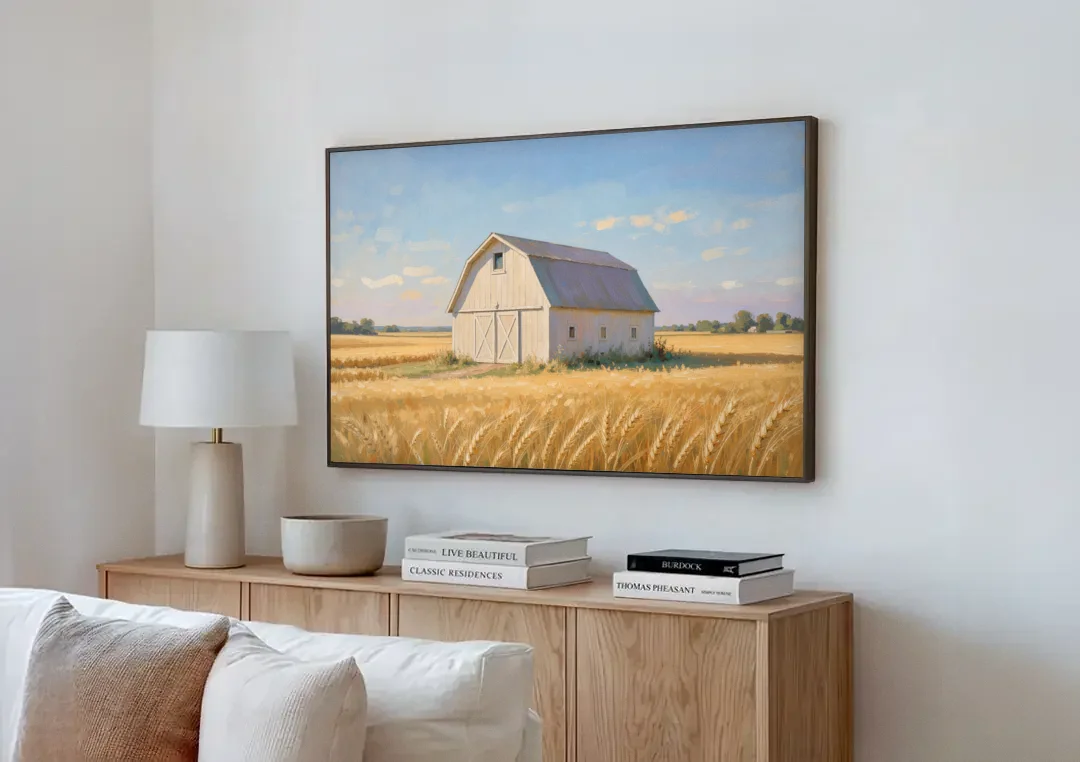 White Barn Beyond the Golden Wheat canvas wall art above a wooden sideboard next to a sofa
