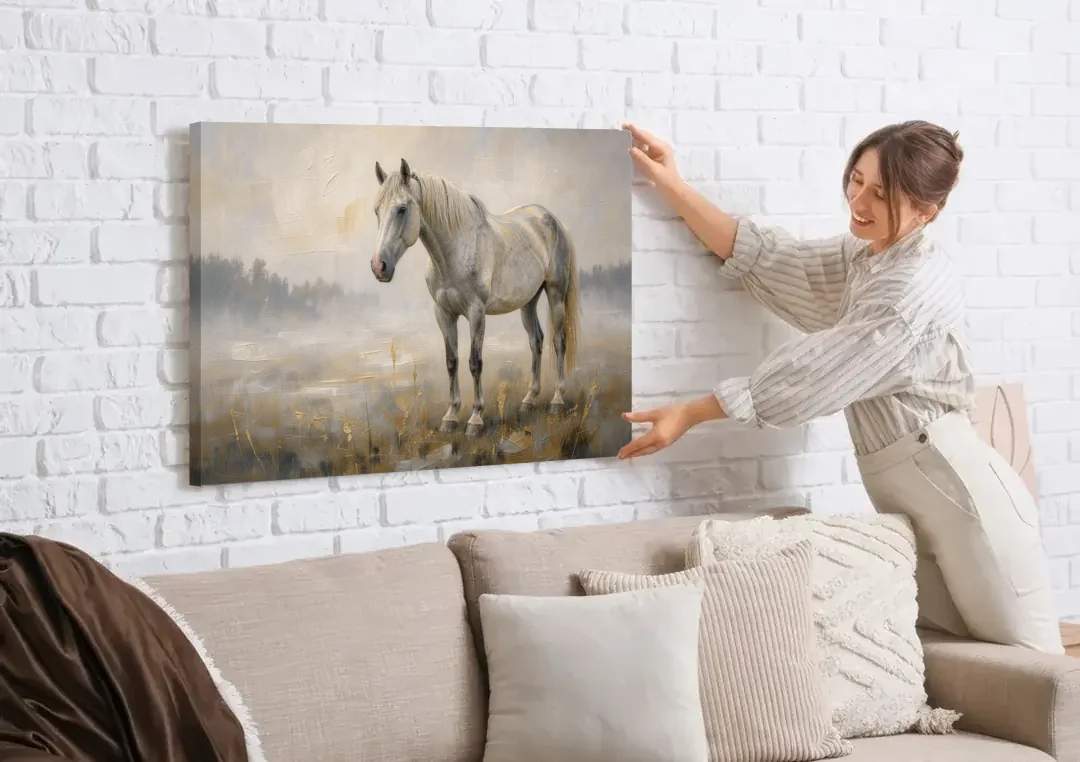 White Horse Painting in Morning Mist canvas wall art being hung on a white brick wall above a sofa