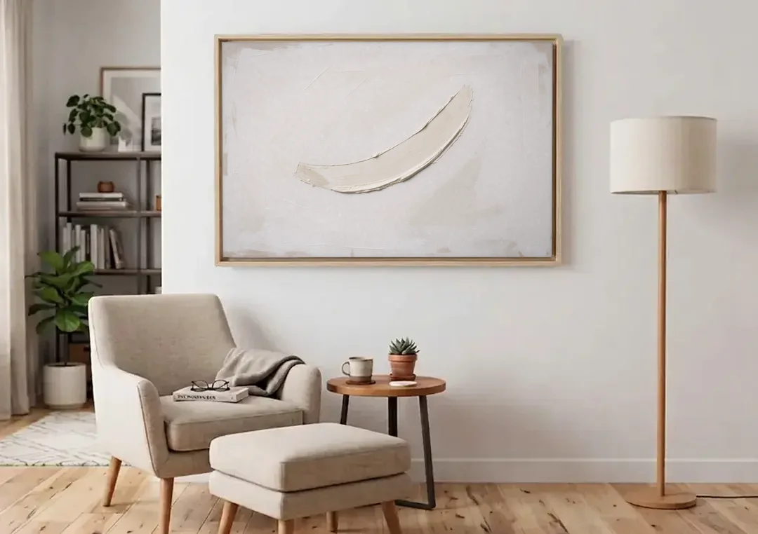White on White Painting with a Warm Crescent canvas wall art above an armchair in a bright living room