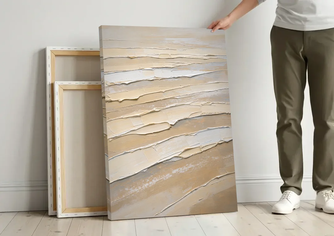 White Textured Painting of Low Tide Ridges canvas wall art leaning against a wall next to blank canvases