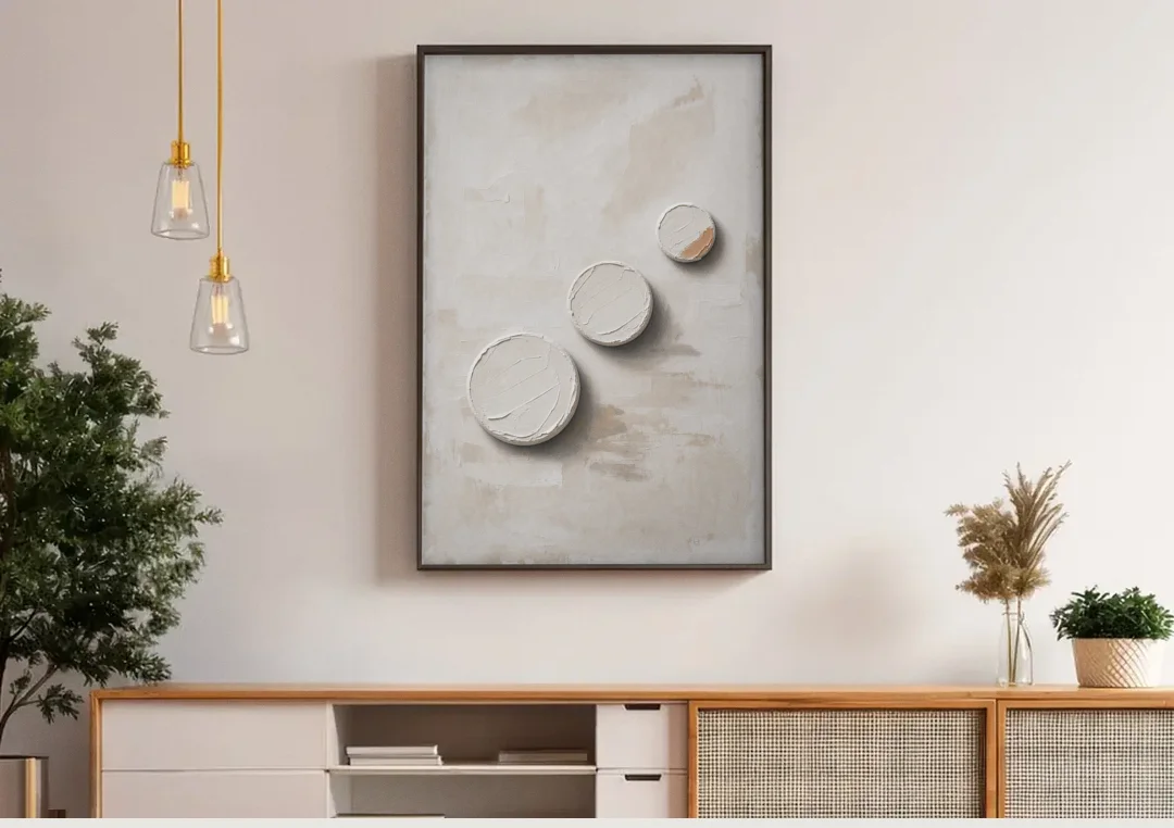 White Textured Wall Art of Three Rising Discs canvas wall art above a wooden sideboard under pendant lights