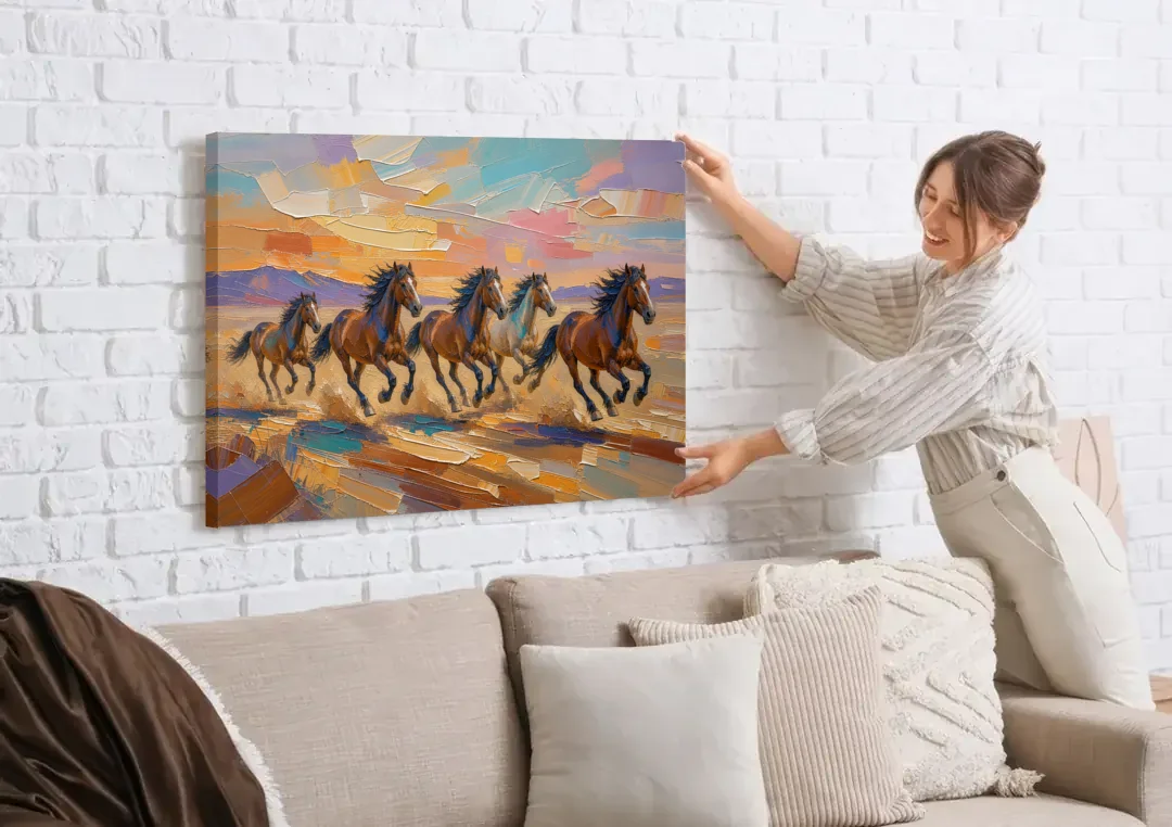 Wild Horses Painting Through Desert Dust canvas wall art being hung on a white brick wall above a sofa