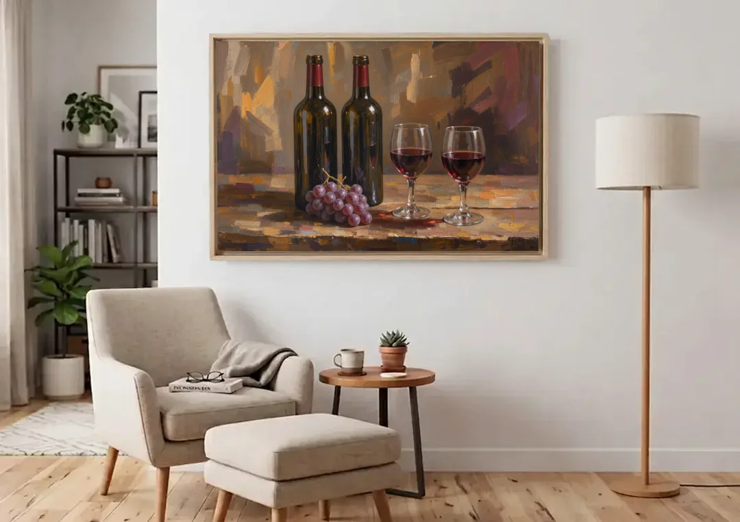 Wine Decor Wall Art with Two Bottles and Grapes canvas wall art above an armchair in a bright living room