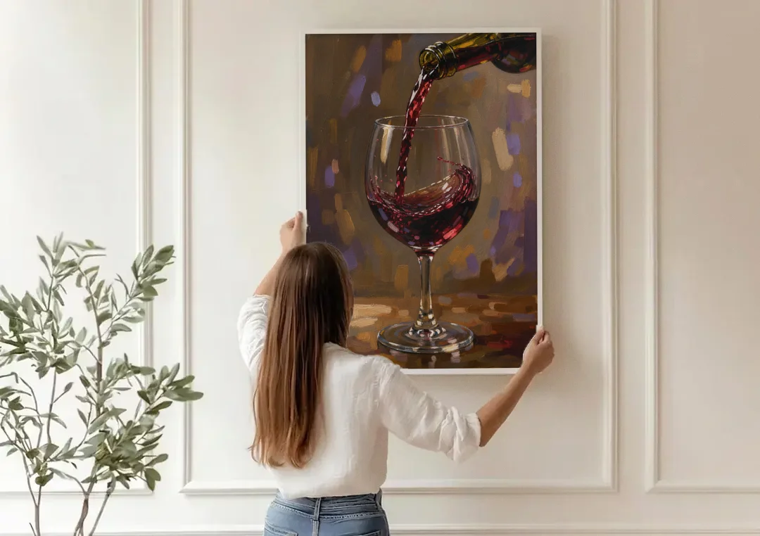 Wine Glass Wall Art with a Swirling Red Pour canvas wall art being hung on a paneled wall