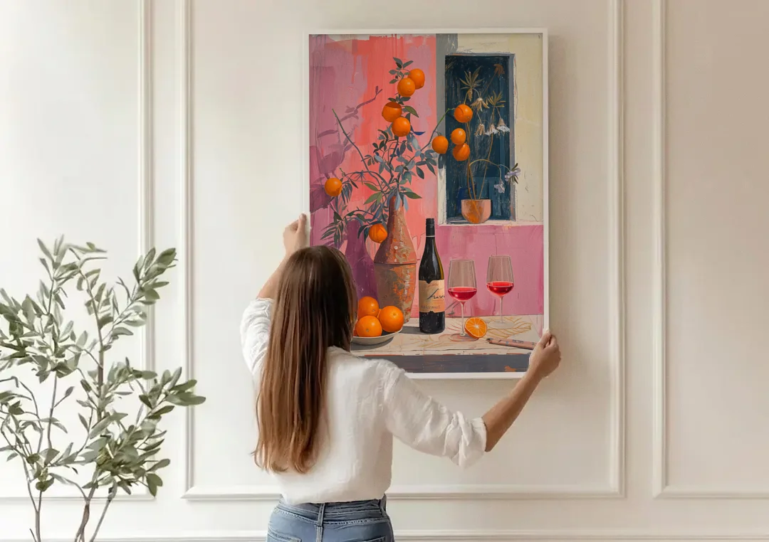 Wine Painting with Oranges on Pink canvas wall art being hung on a paneled wall