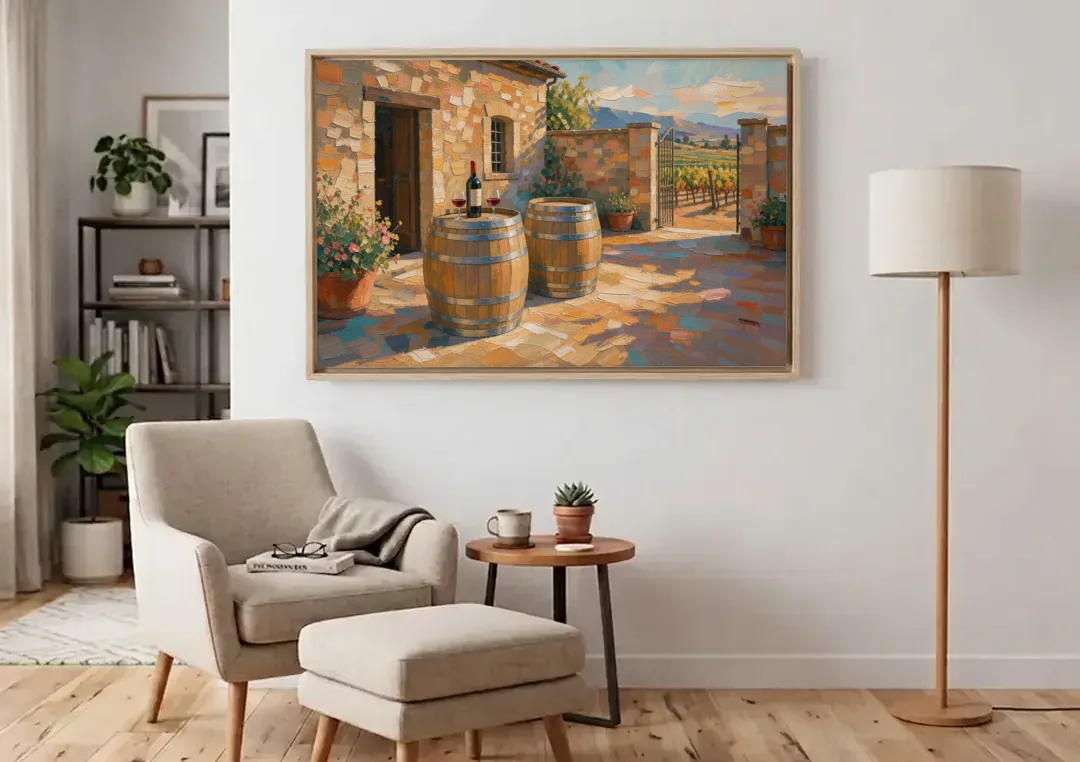 Winery Wall Art of Sunlit Barrel Tables canvas wall art above an armchair in a bright living room