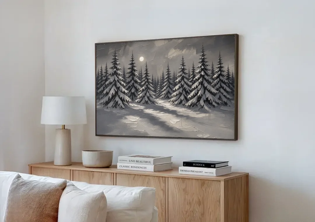 Winter Forest Painting Under a Full Moon canvas wall art above a wooden sideboard next to a sofa
