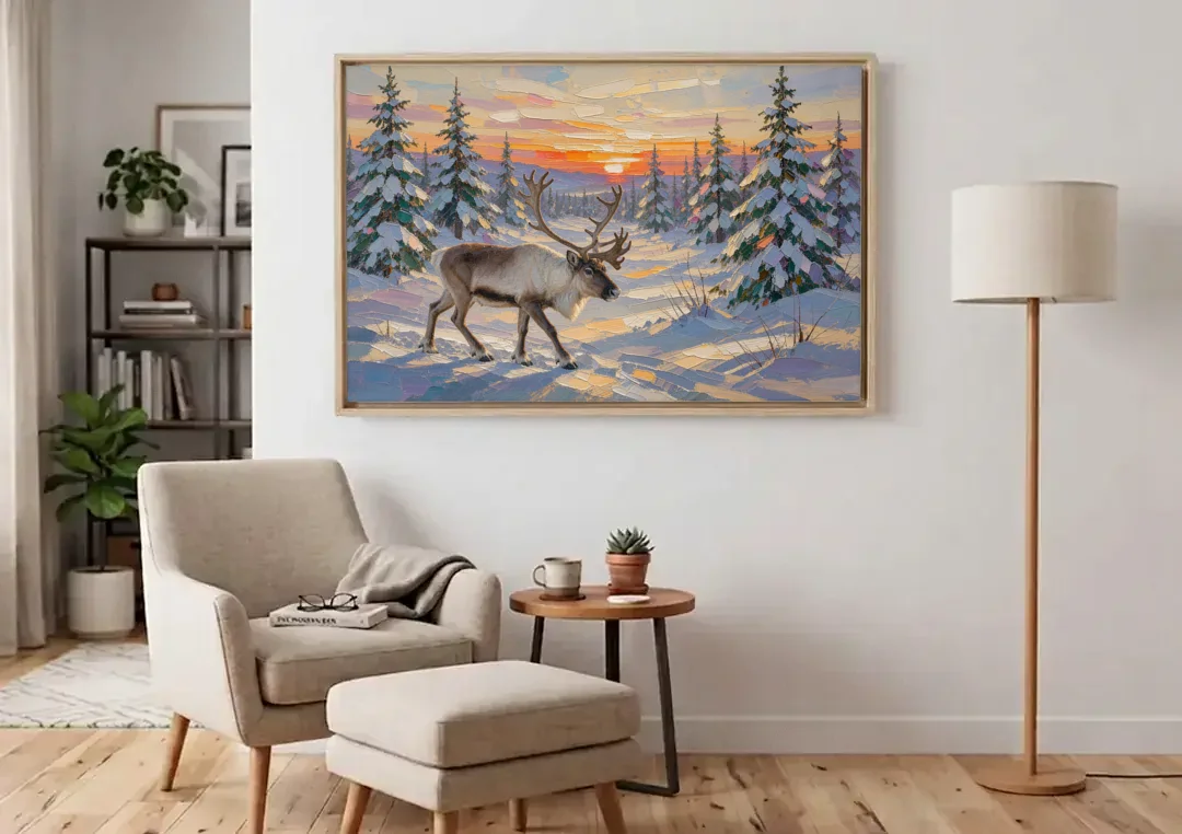 Winter Landscape Painting with a Lone Reindeer canvas wall art above an armchair in a bright living room