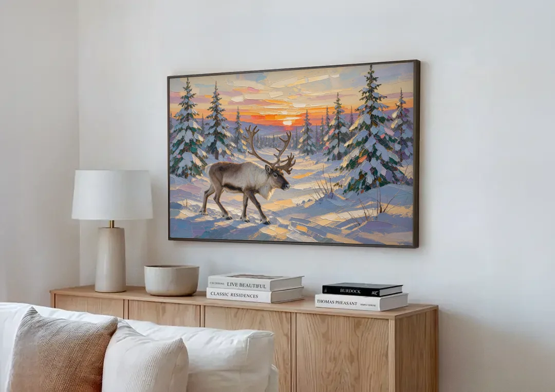 Winter Landscape Painting with a Lone Reindeer canvas wall art above a wooden sideboard next to a sofa