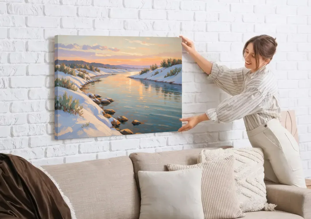 Winter River Painting at Dusk canvas wall art being hung on a white brick wall above a sofa