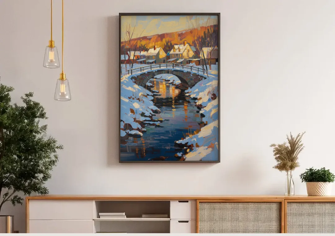 Winter Village Painting with Stone Footbridge canvas wall art above a wooden sideboard under pendant lights